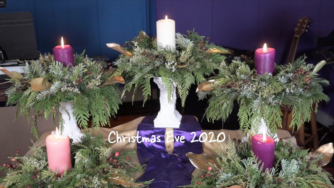A picture of an advent wreath with all candles lit.