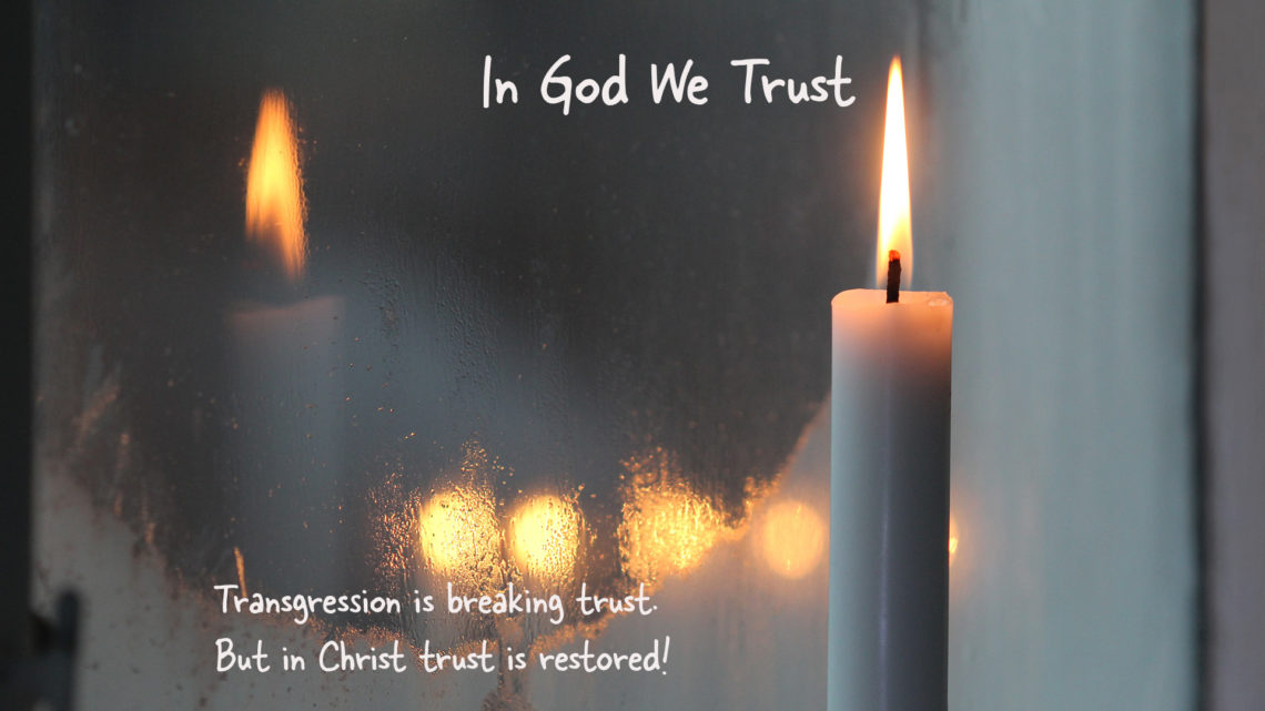 Candle by a frozen window, with words in God We Trust